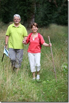 Senior couple rambling in countryside hand in hand